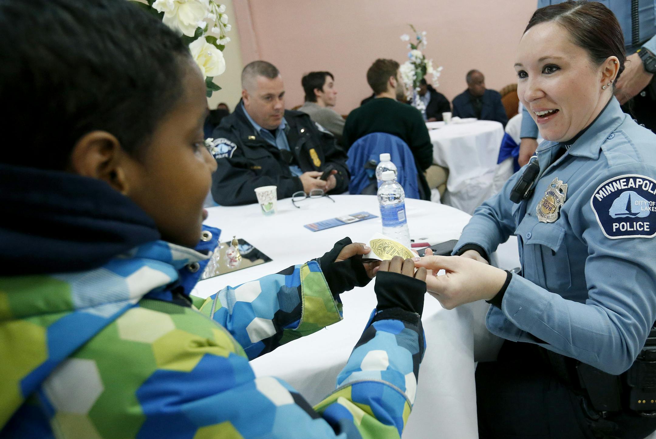 Officer Heather Young of the Minneapolis police passed out stickers to children at the Abubakar As-Saddique in Minneapolis. Abubakar As-Saddique, the largest mosque in Minnesota hosted an open house on Wednesday. ] CARLOS GONZALEZ cgonzalez@startribune.com - April 6, 2016, Minneapolis, MN, Abuubakar mosque on 13th Av. So. in Minneapolis is hosting an open house for the neighborhood, Abubakar As-Saddique, the largest mosque in Minnesota, will open its doors to neighbors and non-Muslim community m