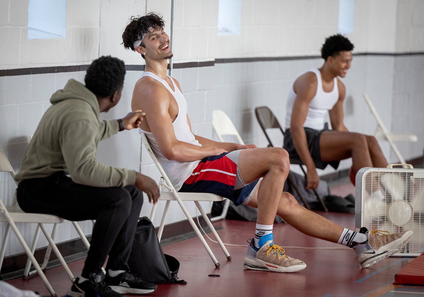 Dawson Garcia, an incoming transfer for the Gophers from North Carolina, via Marquette and Prior Lake, shares a laugh with Hoops and Christ founder Chauncee Hollingsworth, left, as he practices with a their training team at a North Minneapolis gym in Minneapolis, Minn., on Tuesday, May 24, 2022. ] Elizabeth Flores • liz.flores@startribune.com