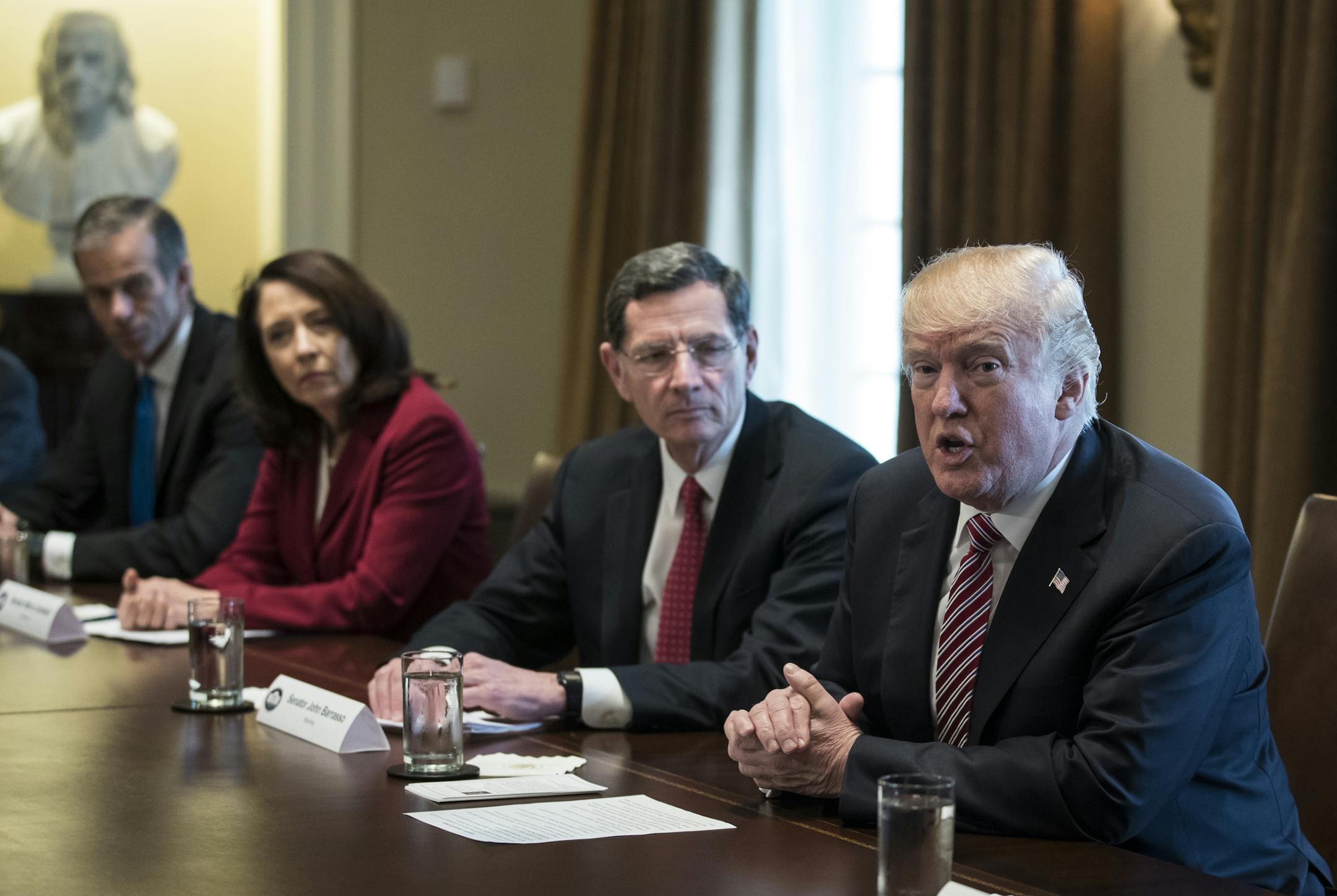 President Donald Trump, joined by from left, Sen. John Thune, R-S.D., Sen. Maria Cantwell, D-Wash., and Sen. John Barrasso, R-Wyo., speaks to media during a meeting with bipartisan Members of Congress about infrastructure in the Cabinet Room of the White House in Washington, Wednesday, Feb. 14, 2018. (AP Photo/Carolyn Kaster)