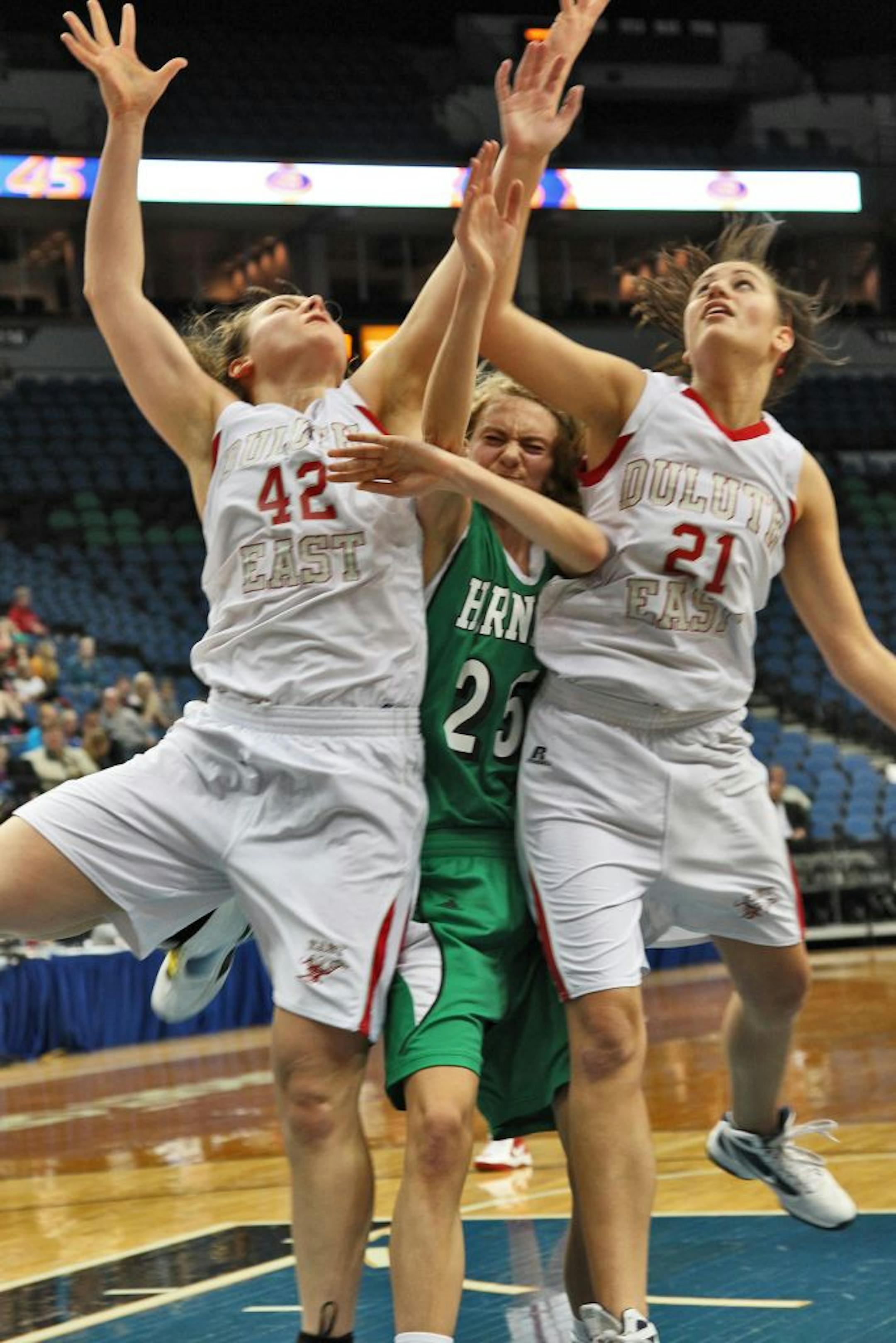 Edina's Lindsey Johnson had the defensive squeeze applied to her by Duluth East's Elena Lushine (42) and Nikki Roseth (21) at Target Center. The Greyounds led 44-42 with 4:09 to play before losing.