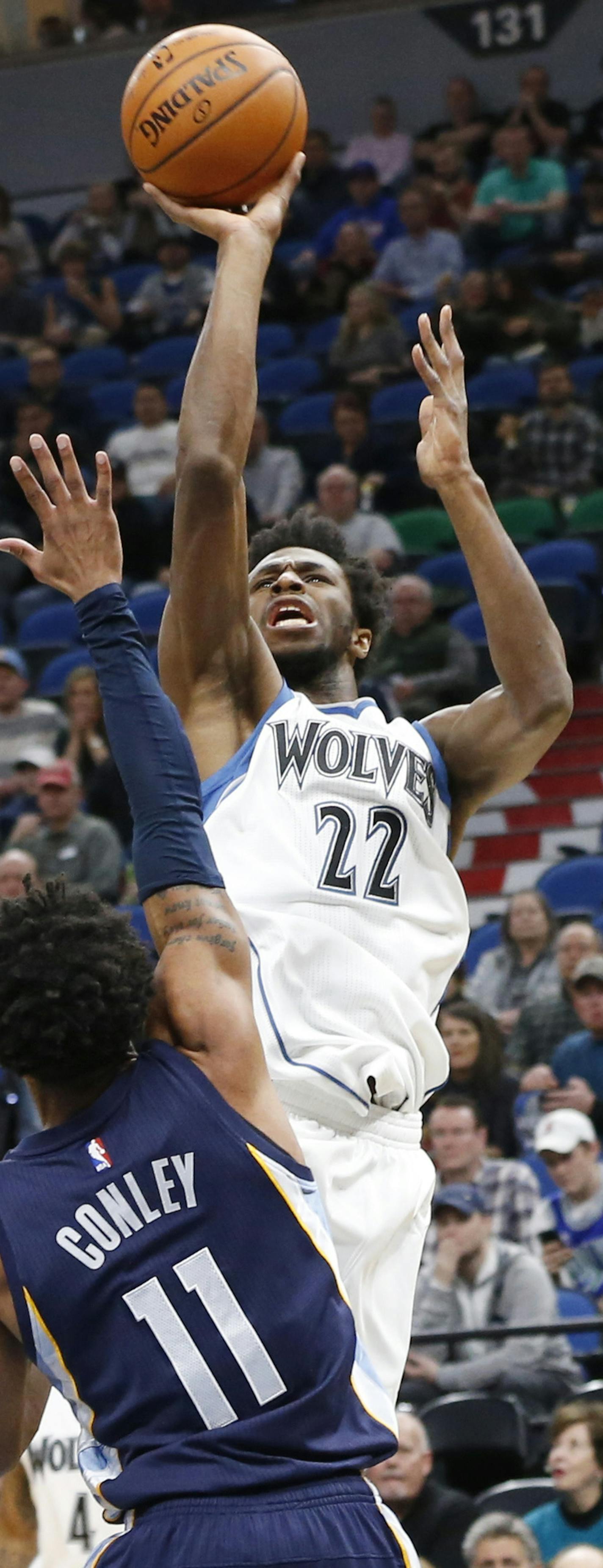 Minnesota Timberwolves' Andrew Wiggins, right, shoots over Memphis Grizzlies' Mike Conley during the first quarter of an NBA basketball game Saturday, Feb. 4, 2017, in Minneapolis. (AP Photo/Jim Mone)