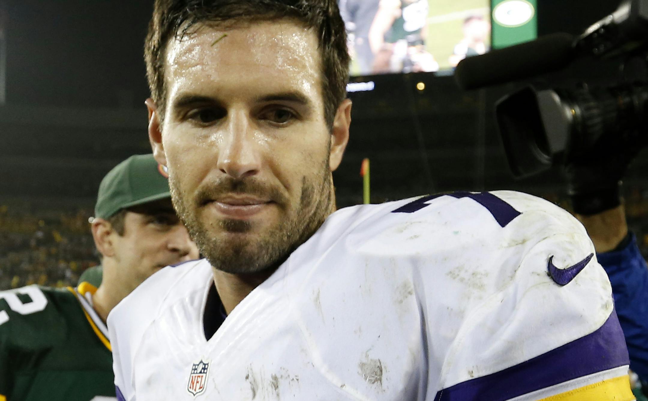 Vikings quarterback Christian Ponder (7) walked away from Packers quarterback Aaron Rodgers (12) after shaking hands at the end of the game. Green Bay beat Minnesota by a final score of 42-10. ] CARLOS GONZALEZ cgonzalez@startribune.com - October 2, 2014 , Green Bay, WI NFL, Lambeau Field, Minnesota Vikings vs. Green bay Packers