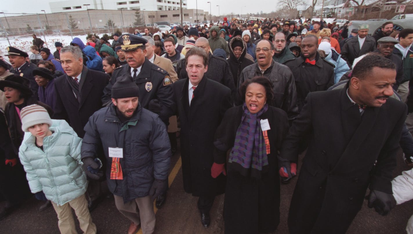 St. Paul, MN. Monday, 1/17/2000. (left to right) Kelsey Peterson of St. Paul, Senator Paul Wellstone, St. Paul Police Chief William Finney, St. Paul Mayor Norm Coleman, Minneapolis Mayor Sharon Sayles Belton and Tyrone Terrill, St. Paul Director of Human Rights led hundreds of people as they marched from St. Paul Central High as part of Martin Luther King day celebration. The Martin Luther King day rally and march began at 9 a.m. at Central High School with speeches by Senator Paul Wellstone, pe