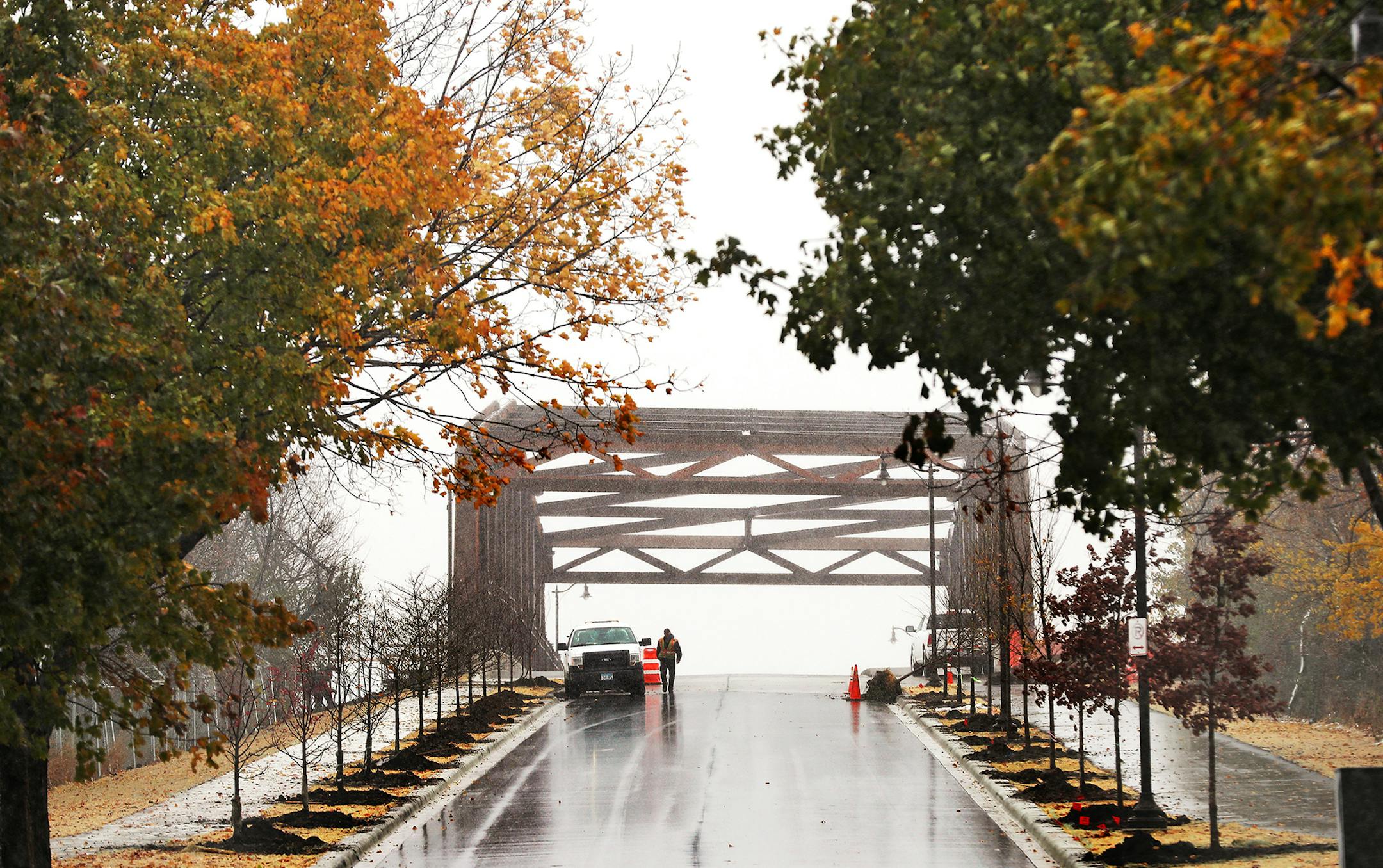 A landscape worker walks along the newly opened St. Anthony Parkway Bridge while doing some lanscape work along the bridge. ] LEILA NAVIDI ï leila.navidi@startribune.com BACKGROUND INFORMATION: The new St. Anthony Parkway Bridge in northeast Minneapolis reopened on Friday, October 28, 2017.