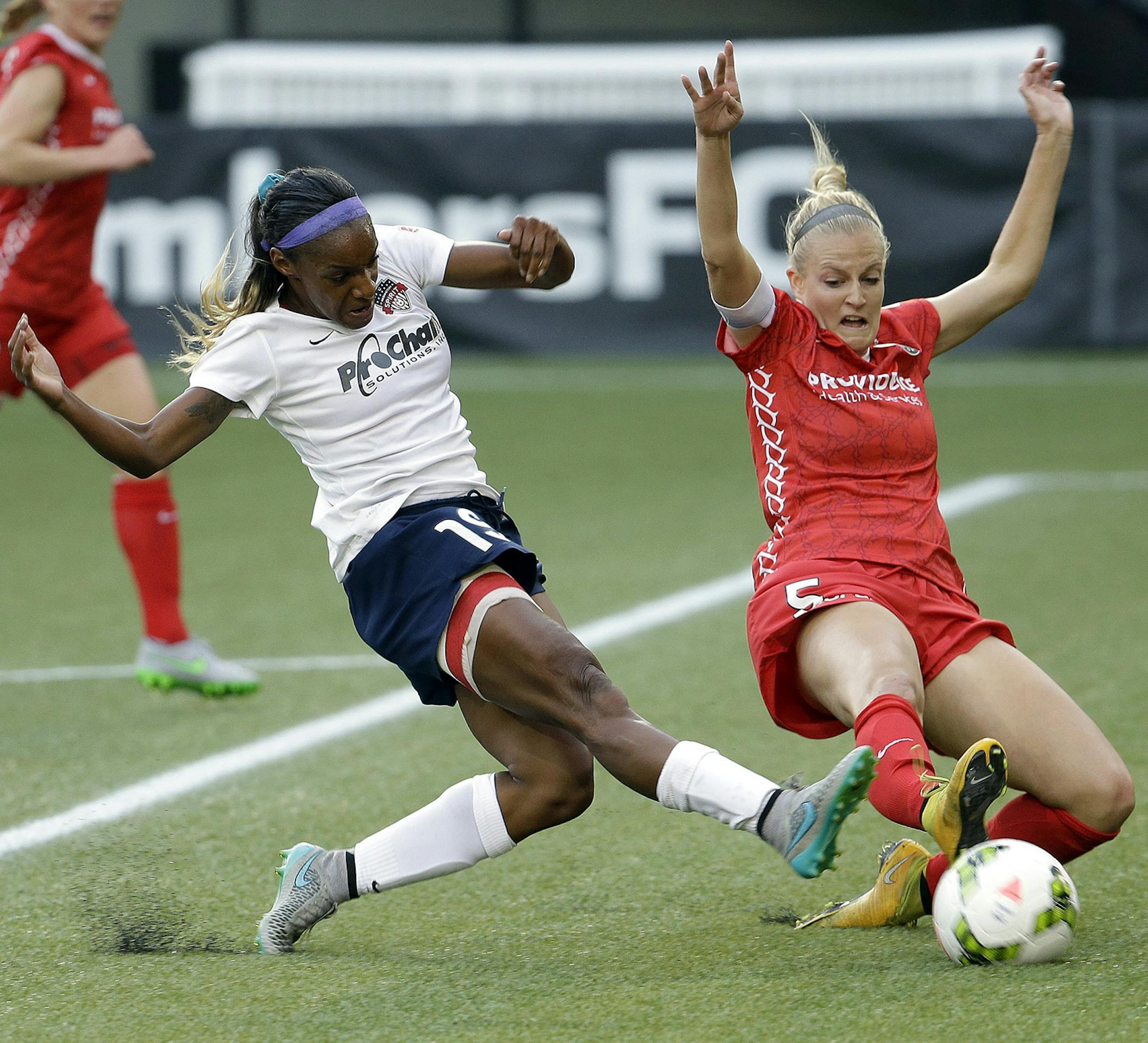 CORRECTS FINAL SCORE TO 3-3 FROM 2-2. Washington Spirit defender Crystal Dunn, left, takes a shot on goal as Portland Thorns defender Kat Williamson dives in during the first half of an NWSL soccer match in Portland, Ore., Sunday, Aug. 30, 2015. The teams tied 3-3. (AP Photo/Don Ryan) ORG XMIT: ORDR101