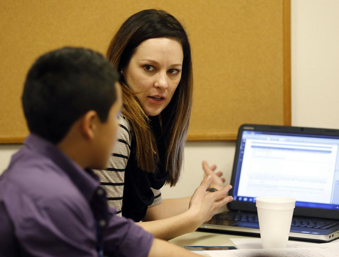 Volunteer Rachel Kingrey helps a juvenile fill out an application during an asylum workshop at Catholic Charities of Dallas on Saturday, Jan. 17, 2015. (Vernon Bryant/Dallas Morning News/TNS)