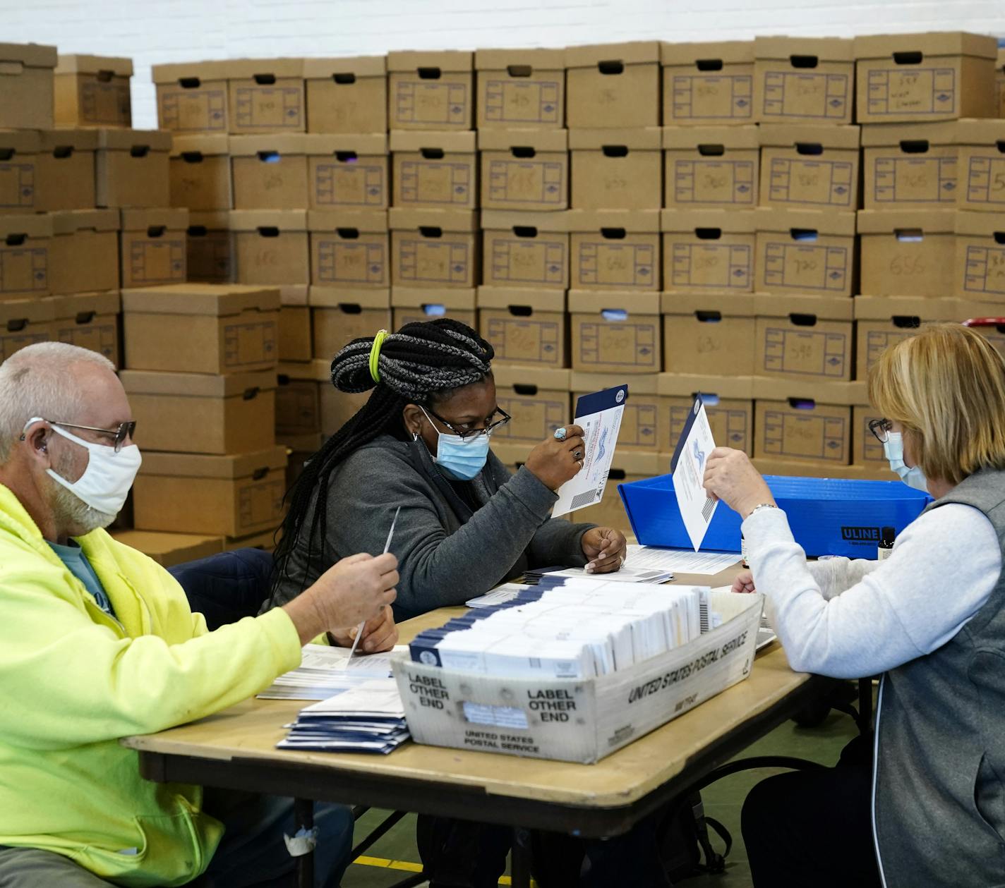 Chester County, Pa., election workers process mail-in and absentee ballots for the 2020 general election in the United States at West Chester University, Wednesday, Nov. 4, 2020, in West Chester., Pa. (AP Photo/Matt Slocum)