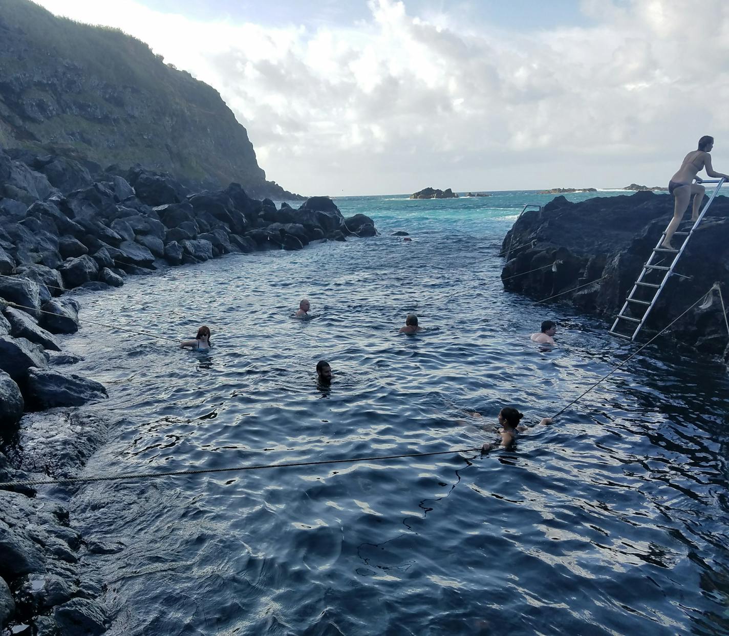 Swimmers ride incoming waves at Ponta da Ferraria, where Atlantic Ocean waters blend with a hot spring during low tide on S&#xe3;o Miguel Island. It&#x2019;s one of several geothermal surprises in Portugal&#x2019;s Azores archipelago. Simon Peter Groebner*simon.groebner@startribune.com