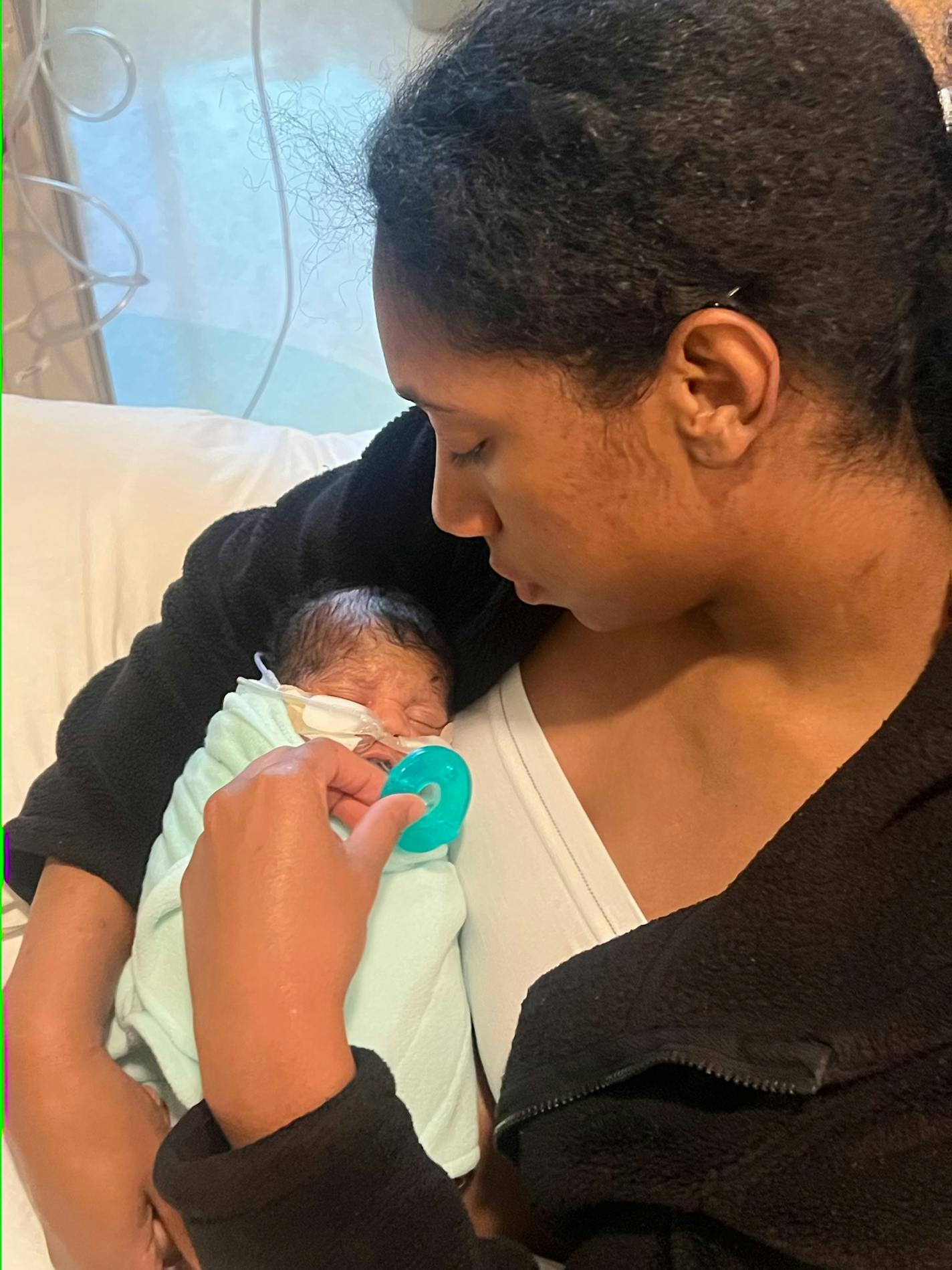 Somya Mirville holds her son, Jayden Mirville-Beamon, in the hospital.