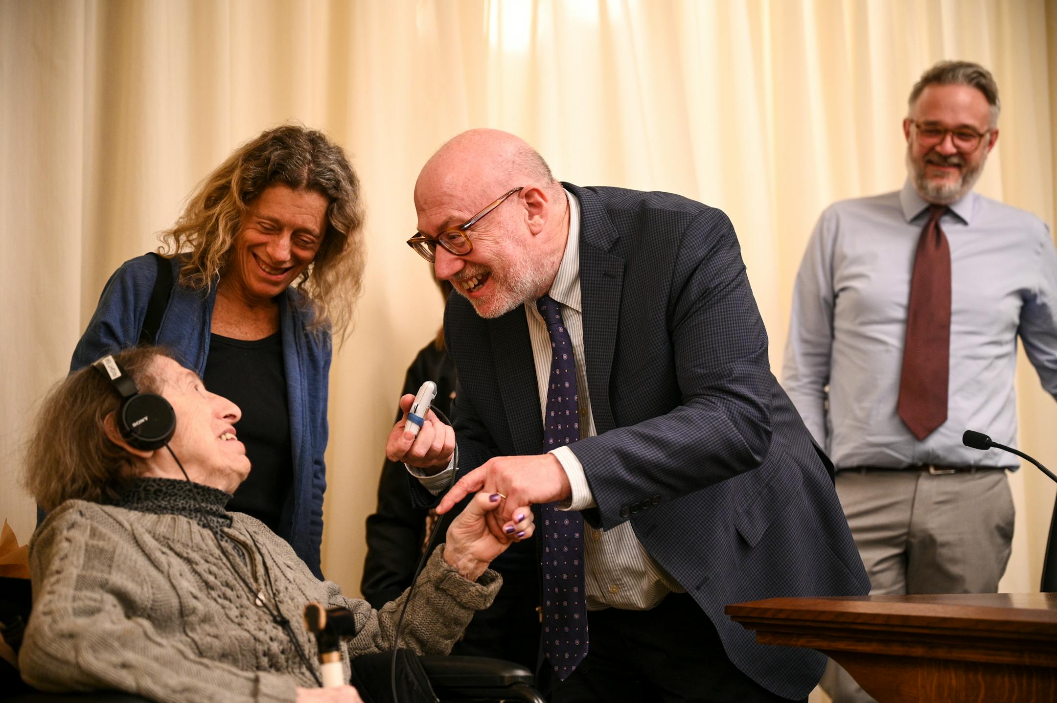Minnesota Rep. Frank Hornstein (DFL-Minneapolis) leans in to congratulate Dora Zaidenweber after a bill he introduced and that Dora testified in support of advanced to the education finance committee.