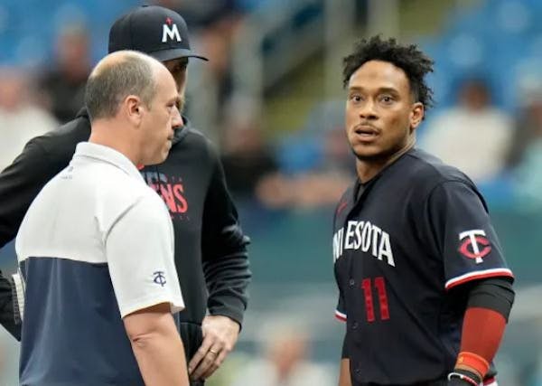 Trainer Nick Paparesta and Twins manager Rocco Baldelli checked out infielder Jorge Polanco (11) during a road game against the Tampa Bay Rays in June