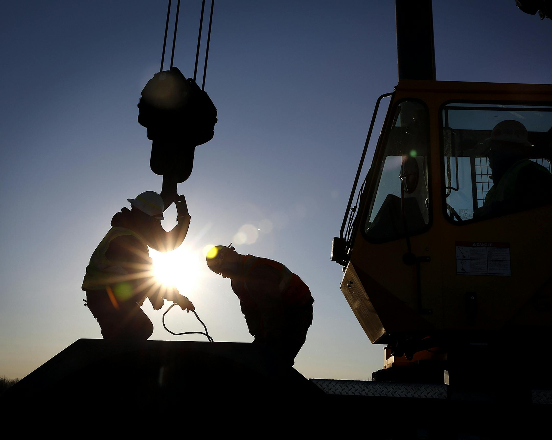 Iron workers set up a crane to move steel for the construction of buildings on the site of Essar Steel Minnesota's taconite mine project in Nashwauk, Minn. ] LEILA NAVIDI leila.navidi@startribune.com / BACKGROUND INFORMATION: Friday, October 31, 2014. Essar Steel Minnesota recently ramped up construction on an $1.8 billion taconite plant after securing the funding needed to complete the project. The plant endured several delays over the past two years as funds periodically ran dry and some contr