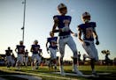 St. Michael-Albertville players ran onto the field for their first game of the season on Aug. 29. Photo: Carlos Gonzalez * cgonzalez@startribune.com
