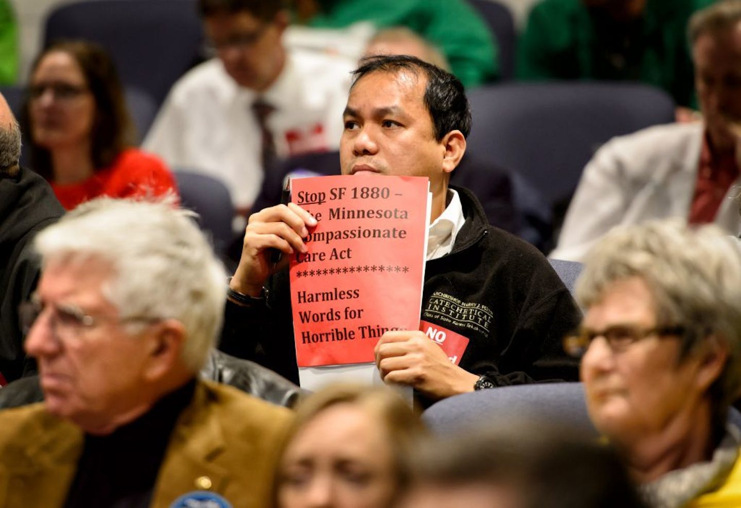 Some in the gallery held signs calling the Compassionate Care Act "Harmless words for horrible things" as the Minnesota Senate heard testimony on the bill Wednesday, March 16.