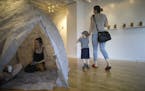 Finnish artist Mari Mathlin sat in a tent-like piece she was exhibiting during the opening for a show of her work at Hair and Nails in Minneapolis.