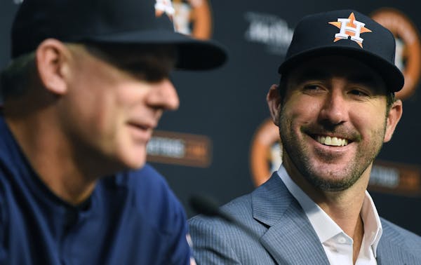 Houston Astros pitcher Justin Verlander, right, listens to manager A.J. Hinch during a press conference introducing Verlander before a baseball game a