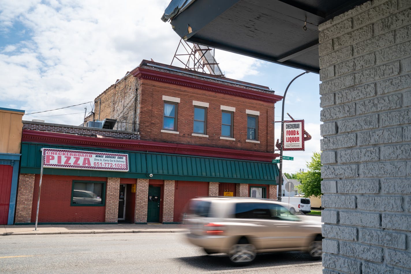 Five St. Paul police officers are accused of standing by as Tou Cha, an ex-police officer, committed the assault outside Checker Board Pizza in the Payne-Phalen neighborhood.