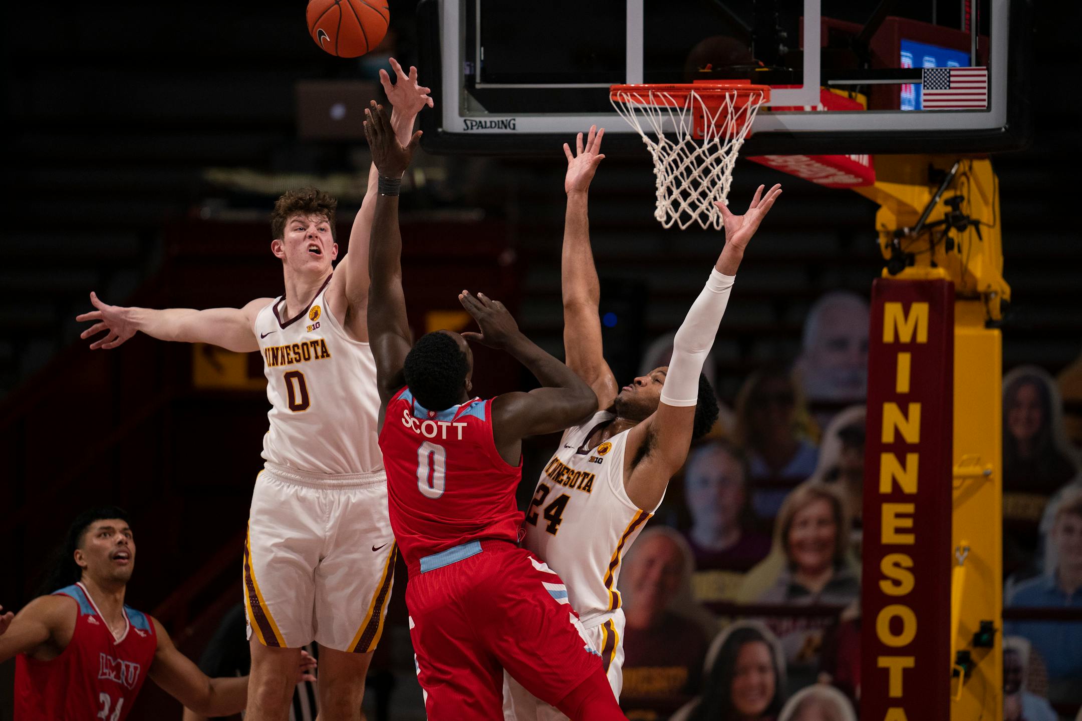 Gophers center Liam Robbins (0) fouled Loyola Marymount guard Eli Scott (0) late in the game Monday night.