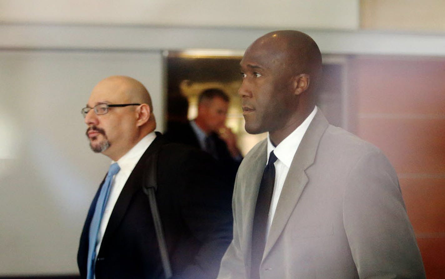 Minneapolis police officer Michael Griffin, right, was accompanied by his attorney, Ryan Kaess, as he left court in May 2015.