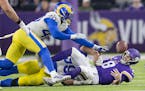 Minnesota Vikings quarterback Kirk Cousins (8) fumbles the ball, which was recovered by Vikings offensive tackle Christian Darrisaw (71), in the fourt