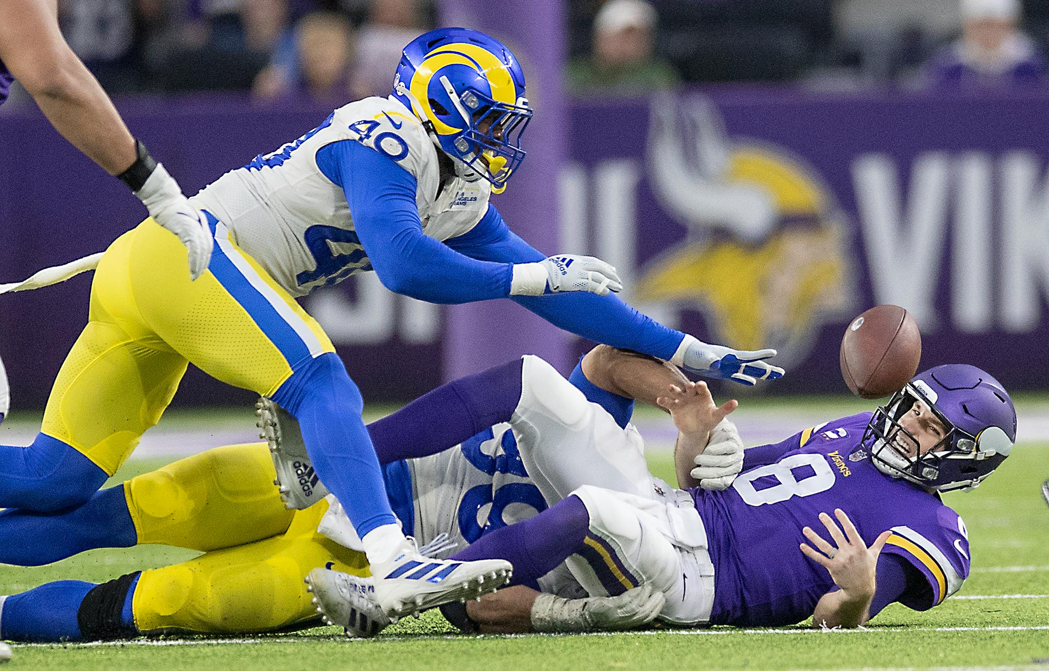 Minnesota Vikings quarterback Kirk Cousins (8) fumbles the ball, which was recovered by Vikings offensive tackle Christian Darrisaw (71), in the fourth quarter against the Los Angeles Rams, Sunday, Dec. 26, 2021 at U.S. Bank Stadium in Minneapolis. (Elizabeth Flores/Minneapolis Star Tribune/TNS) ORG XMIT: 35875594W