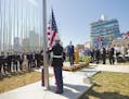 Secretary of State John Kerry, and other dignitaries watch as U.S. Marines raise the U.S. flag over the newly reopened embassy in Havana, Cuba, Friday