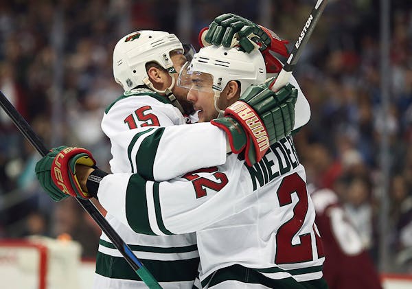 Minnesota Wild teammate Dany Heatley hugs Nino Niederreiter after Niederreiter scored the third goal for the Wild against the Colorado Avalanche durin