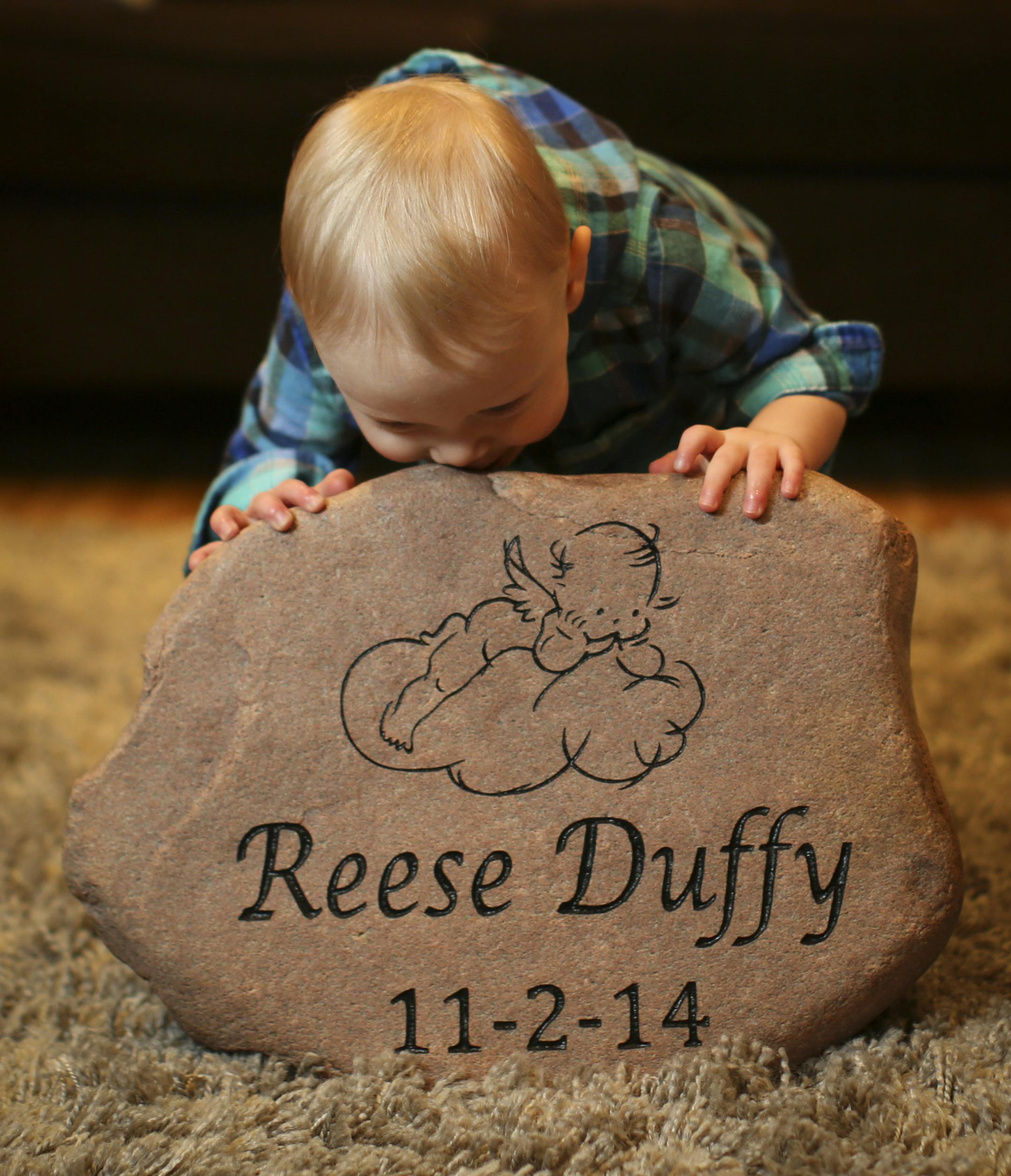 Chris and Amanda Duffy's son Rogen kissed a stone with the name of his baby sister Reese who was born stillborn in November 2014. Photographs taken on Wednesday, March 4, 2015 in Roseville, Minn. ] RENEE JONES SCHNEIDER • reneejones@startribune.com