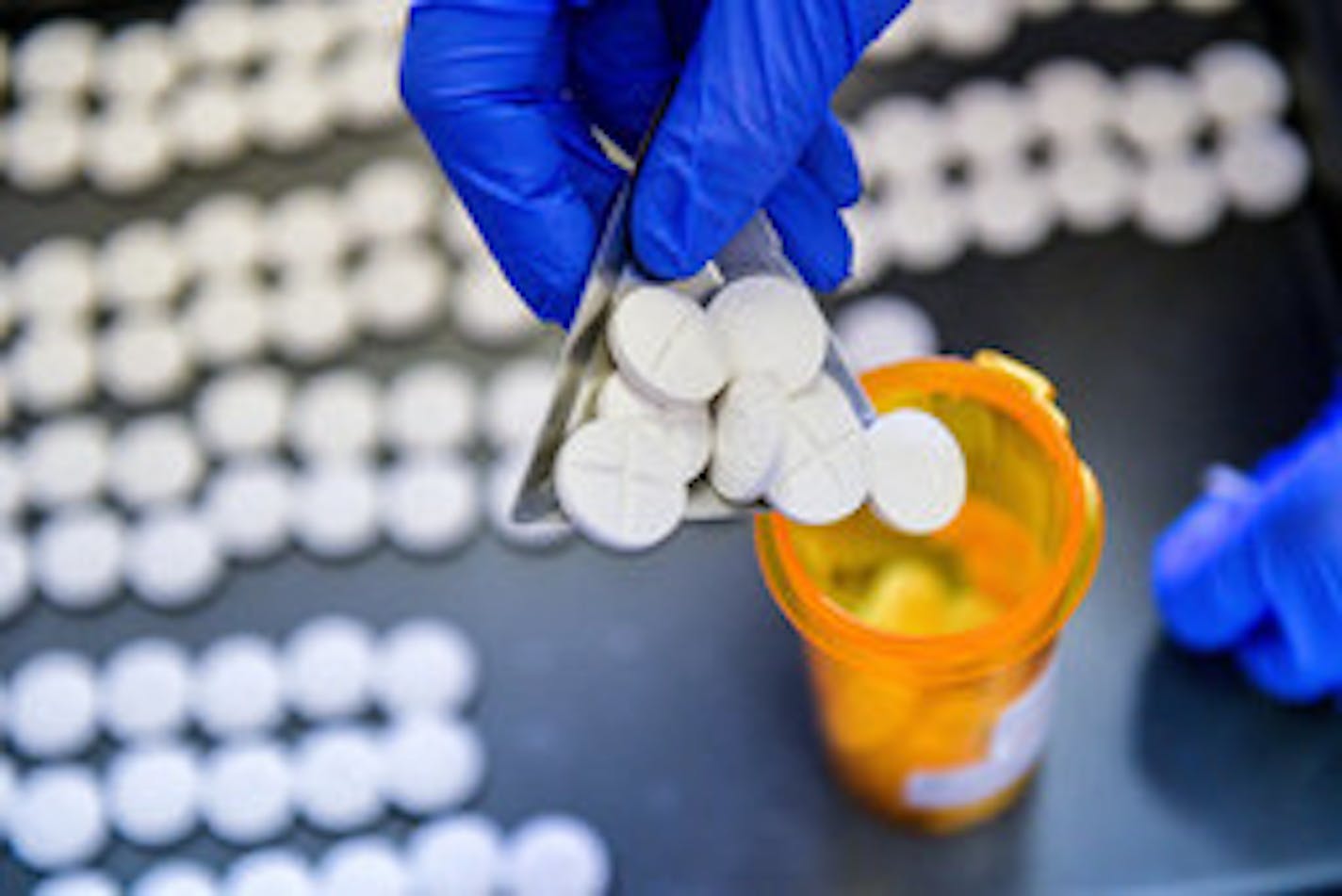 In this Sept. 5, 2018 photo, RN Teresa Smith carefully counts out doses of methadone in the lab at the Human Service Center, in Peoria, Ill. The center specializes in the intake and assessment of individuals with drug and alcohol abuse, offering psychiatric assessment and medication treatment services for those battling opioid and other addictions.