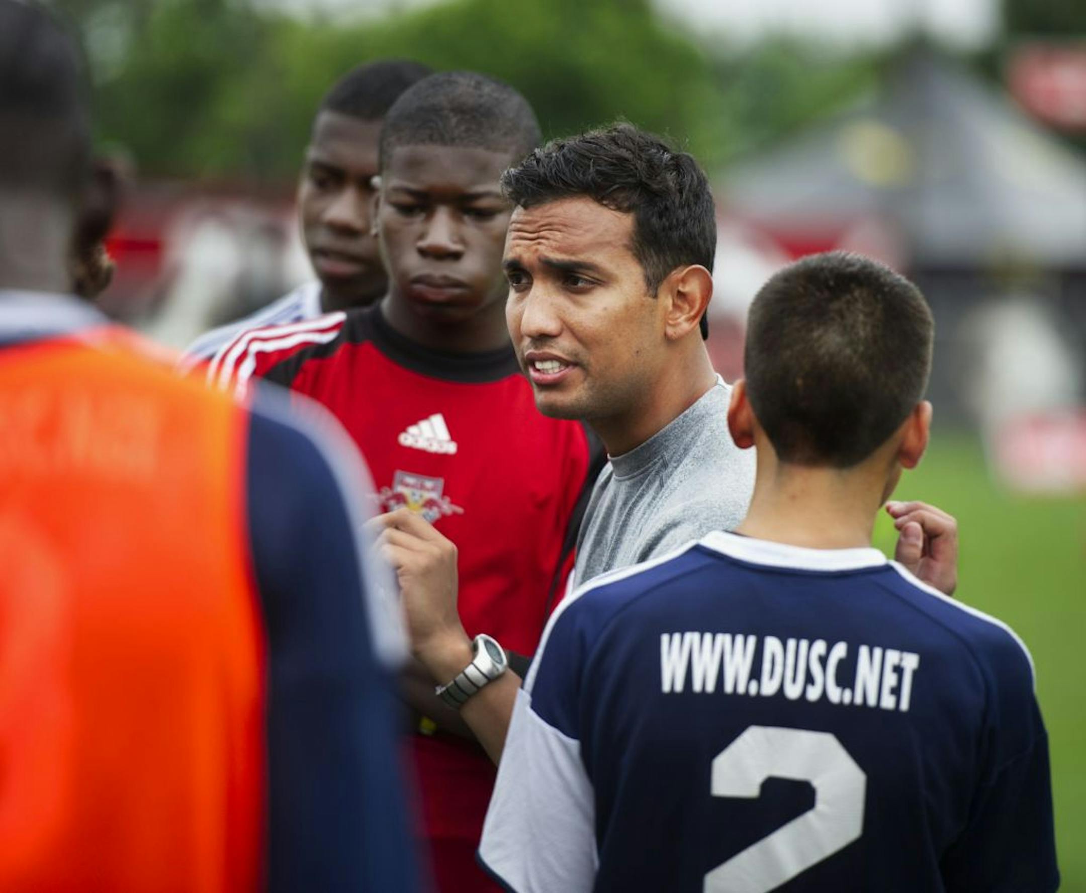 Downtown United Soccer Club coach Oscar Cantu talked to his team at halftime during play against the Odyssey Soccer Club, at the National Sports Center in Blaine Saturday.