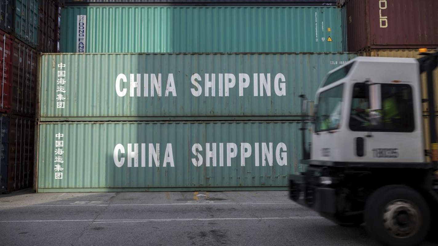 FILE- In this July, 5, 2018, file photo, a jockey truck passes a stack of 40-foot China Shipping containers at the Port of Savannah in Savannah, Ga. China said Tuesday, Sept. 18, that it will take "counter-measures" to U.S. President Donald Trump's decision to raise tariffs on $200 billion of Chinese imports and an American business group warned a "downward spiral" in their trade battle appears certain.