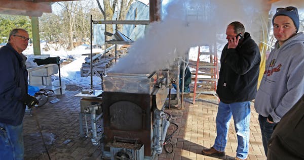 Jim Smith, left, Dave Swager and Vince Anderson, right, boil maple sap as as their animal spring syrup making ritual began in earnest last week.