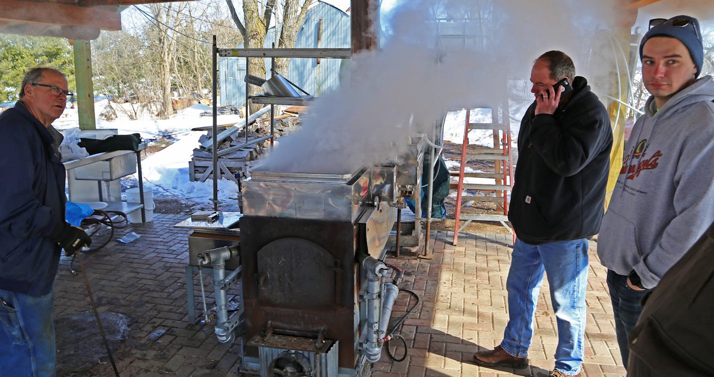 Jim Smith, left, Dave Swager and Vince Anderson, right, boil maple sap as as their animal spring syrup making ritual began in earnest last week.