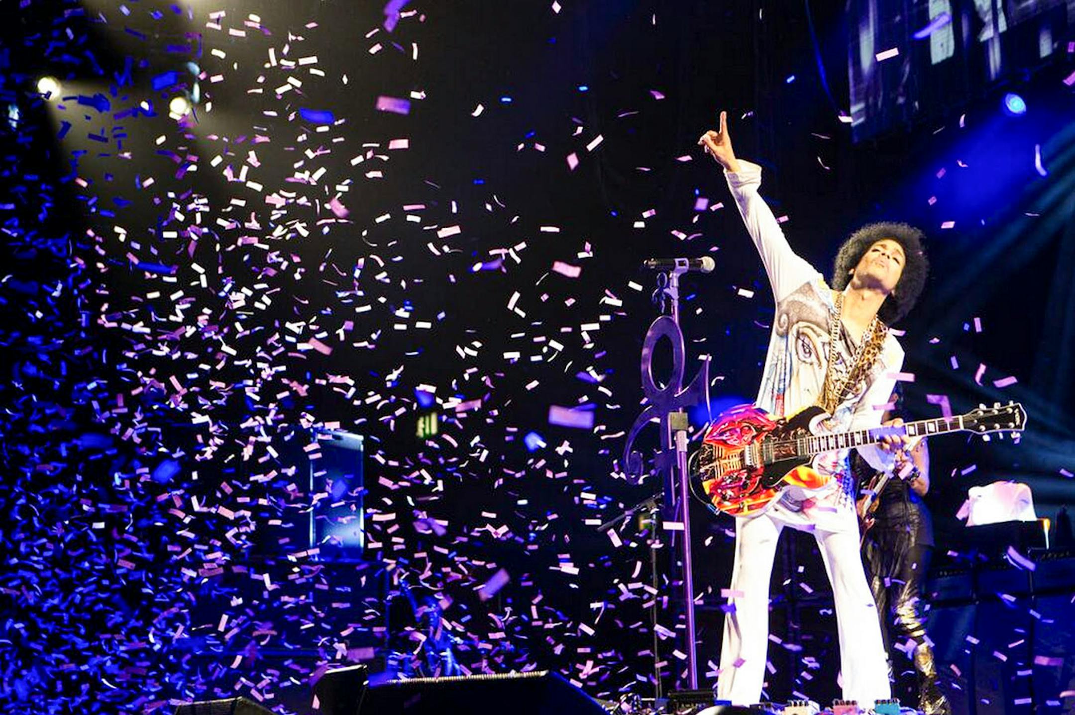 In an undated handout photo, Prince performs in Birmingham, England. In his latest confounding move, Prince has simultaneously released two albums: ìArt Official Age,î a studio production billed as his first solo album since 2010 and ìPlectrumElectrum,î on which heís backed by the three-woman rock trio he has been touring with, 3rdEyeGirl.