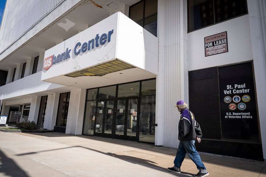 A pedestrian strolled by the U.S. Bank Center in October, a few weeks before the 25-story office tower headed to auction with a starting bid of $1 million, far less than its assessed value. Court records from the summer cited extensive maintenance needs, including elevator malfunctions and code violations in the parking structure.
