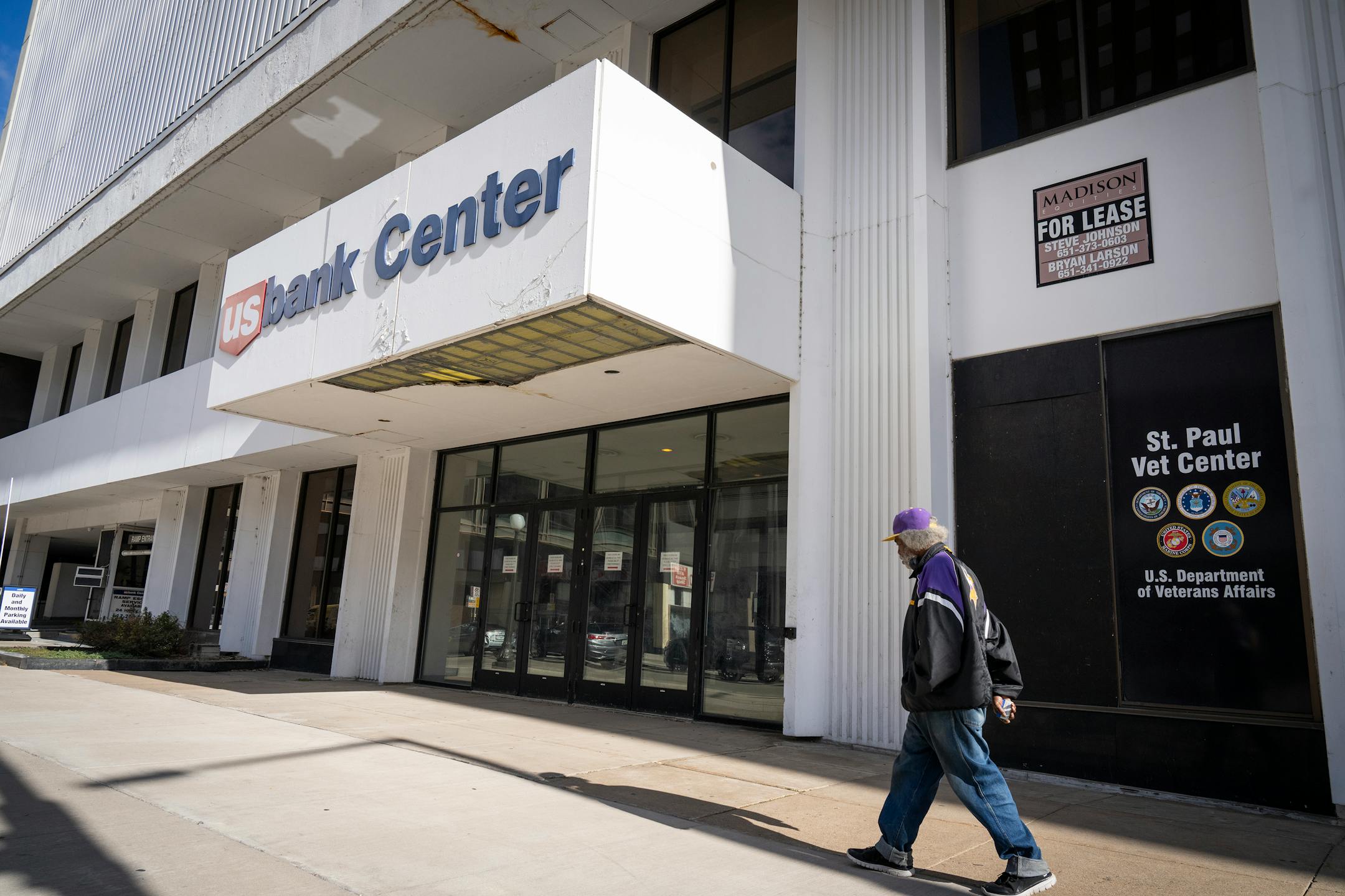 A pedestrian strolled by the U.S. Bank Center in October, a few weeks before the 25-story office tower headed to auction with a starting bid of $1 million, far less than its assessed value. Court records from the summer cited extensive maintenance needs, including elevator malfunctions and code violations in the parking structure.