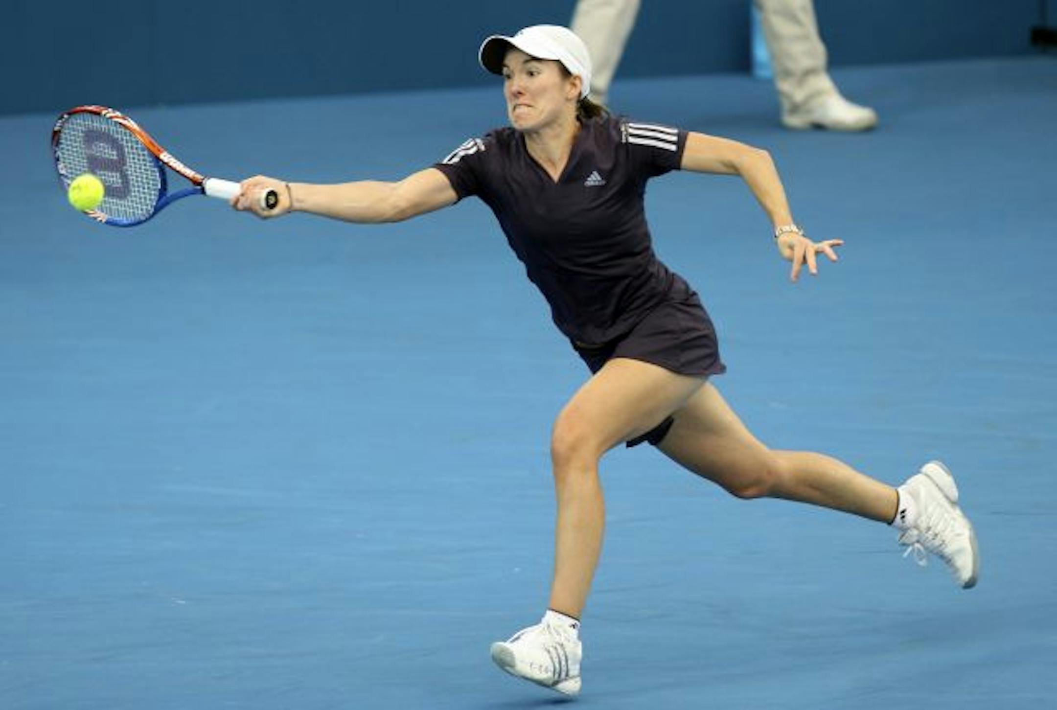 Belgium's Justine Henin reaches out for the ball during her semifinal match against Ana Ivanovic of Serbia at the Brisbane International tennis tournament in Brisbane, Australia, Friday, Jan. 8, 2010. Henin won 6-3, 6-2.