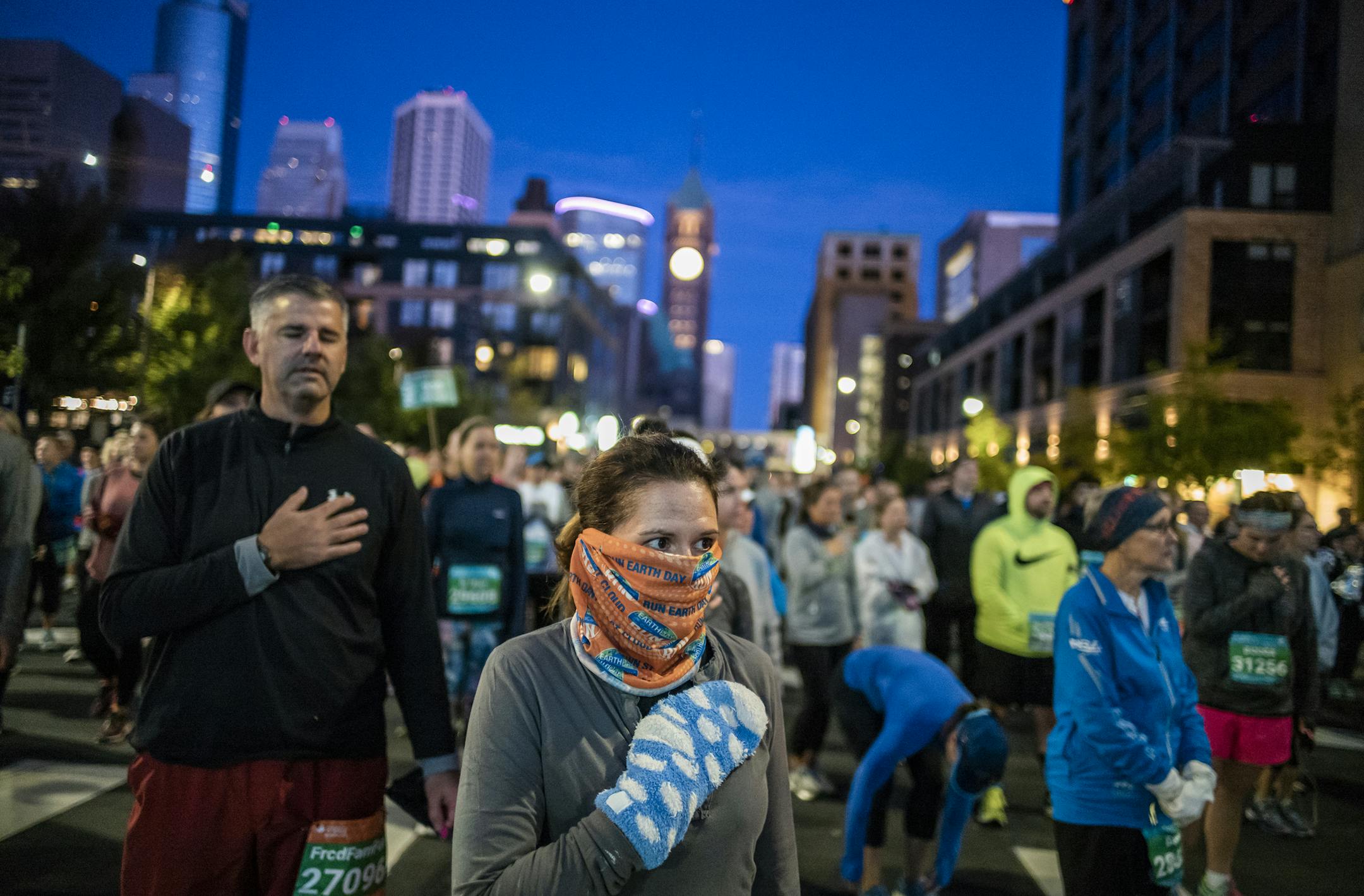 Jennifer Bunkers stands for the National Anthem before the 10K race.] Twin Cities Marathon RICHARD TSONG-TAATARII &#xa5; richard.tsong-taatarii@startribune.com