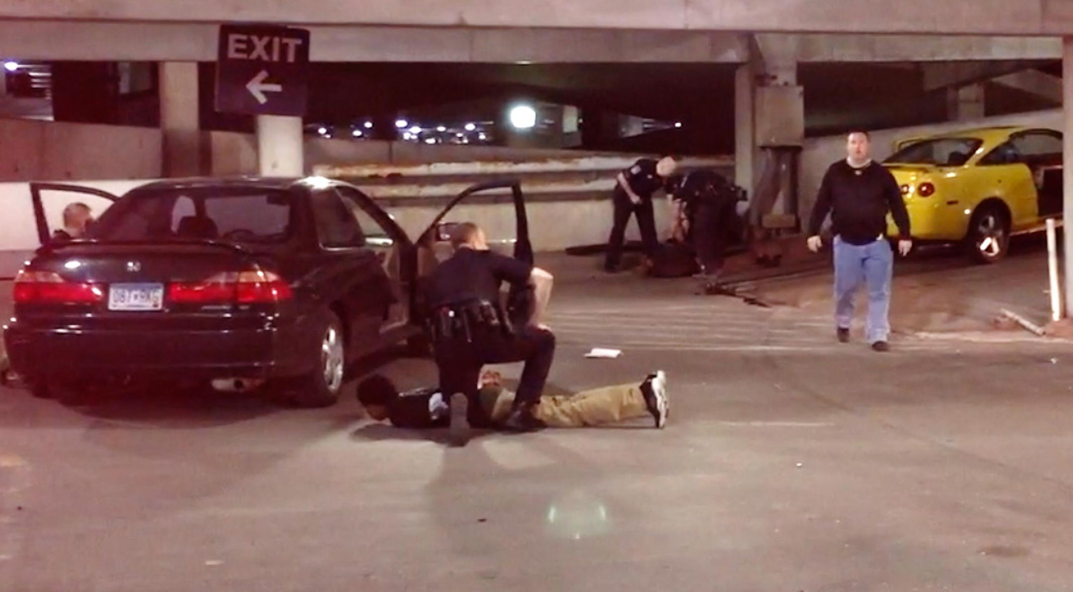 In this still taken from video, Minneapolis-St. Paul International Airport police secure a suspect after a police-involved shooting in an airport parking ramp.