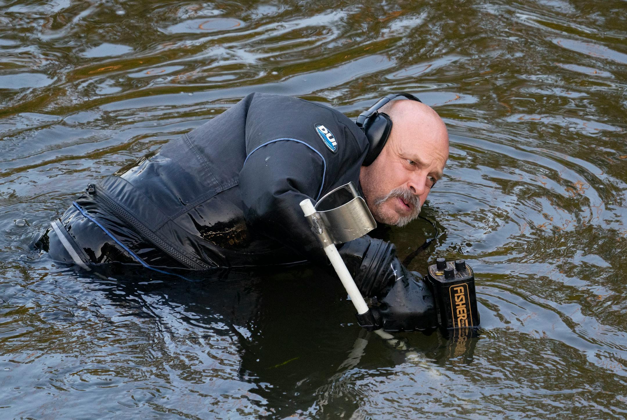 Water Recovery authorities comb the Apple River with metal detectors after five people were stabbed while tubing down the river Saturday, July 30, 2022 in Somerset, WI.   ]