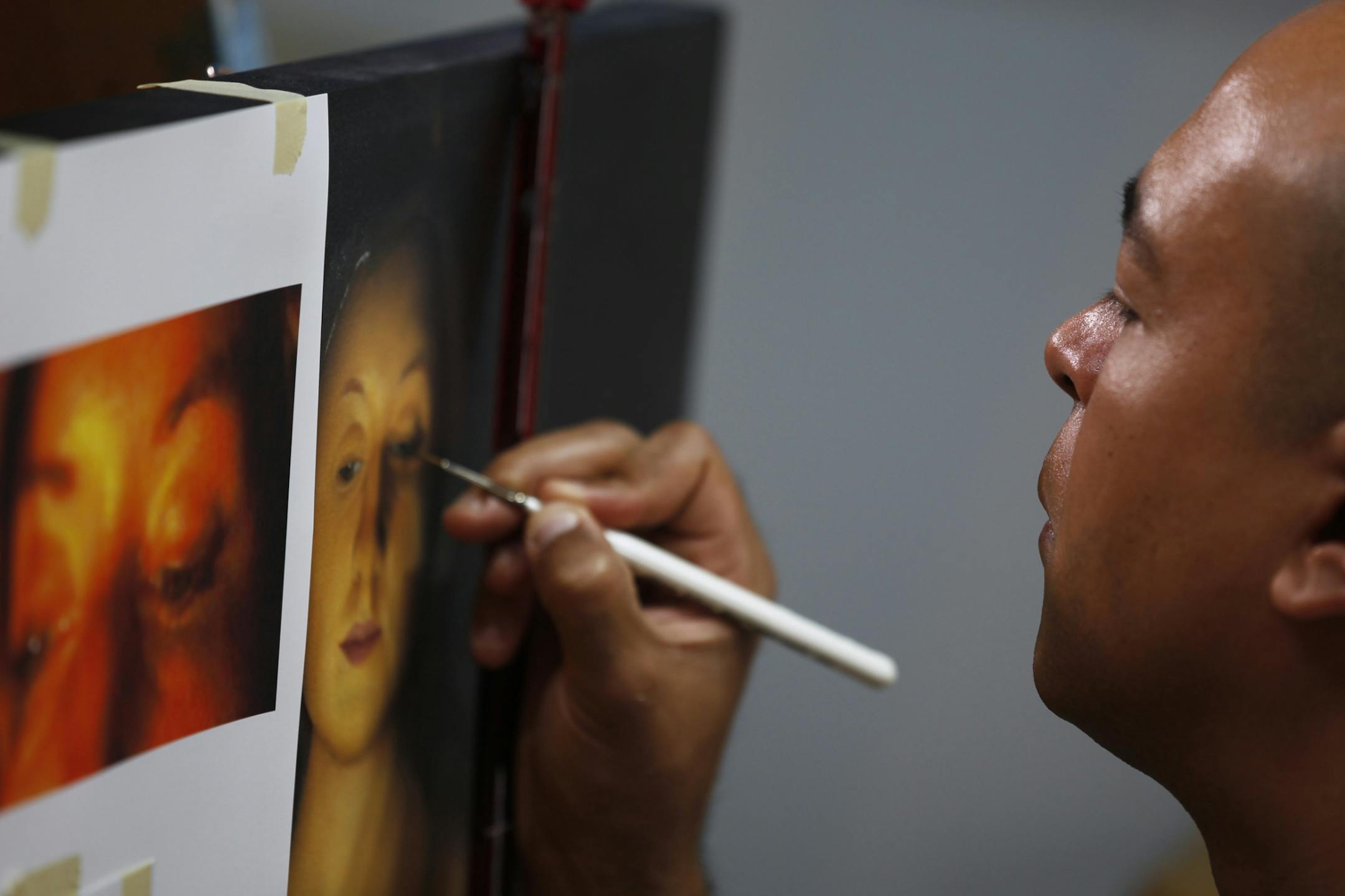 Matthew Rucker worked on a painting at his apartment/studio Wednesday June 20, 2012 in St. Paul. Rucker lives in the Northern Warehouse building in St. Paul.