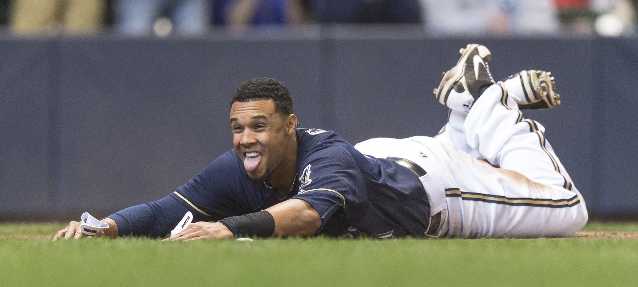 Milwaukee Brewers' Carlos Gomez slides home safely on a Jonathan Lucroy two RBI single off of St. Louis Cardinals' Seth Maness during the fifth inning of a baseball game Wednesday, April 16, 2014, in Milwaukee. (AP Photo/Tom Lynn)