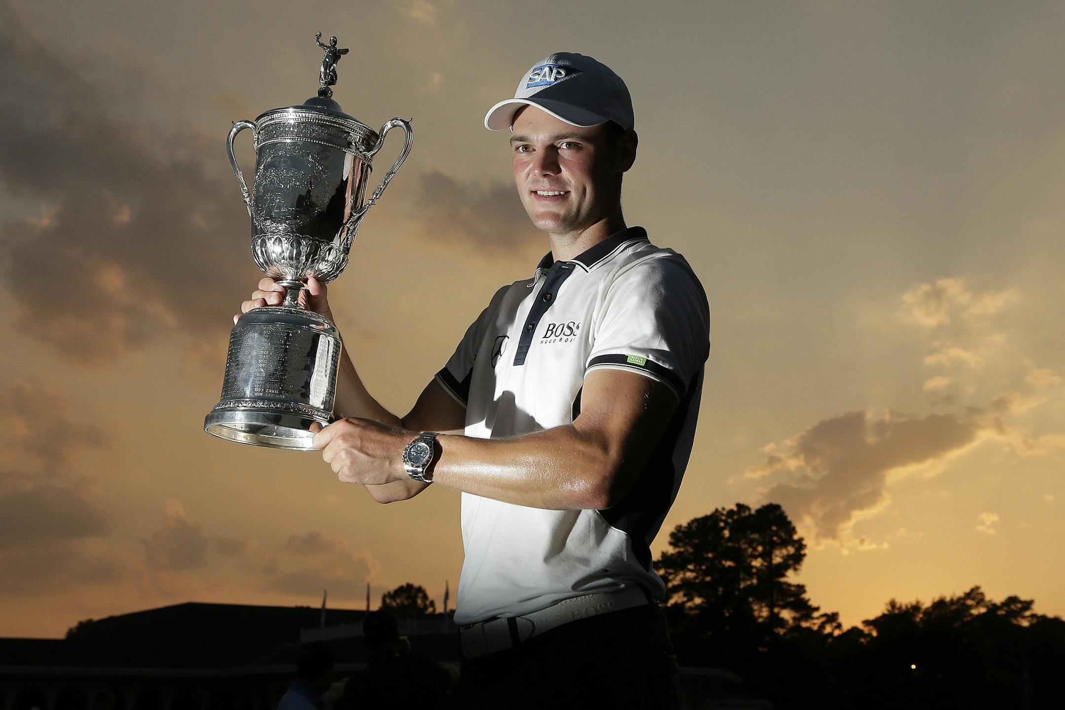 Martin Kaymer, of Germany, poses with the trophy after wining the U.S. Open golf tournament in Pinehurst, N.C., Sunday, June 15, 2014. (AP Photo/Charlie Riedel)