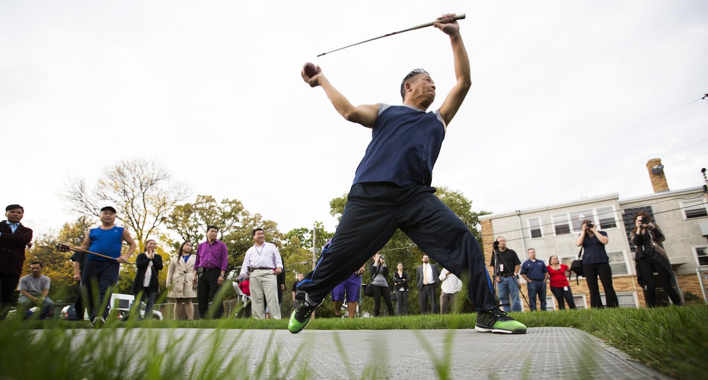 Chia Chue Yang demonstrates the game of Tuj Lub for onlookers and media during the grand opening of the state's first Tuj Lub courts in St. Paul. ] (Leila Navidi/Star Tribune) leila.navidi@startribune.com BACKGROUND INFORMATION: St. Paul opens the state's first Tuj Lub courts at the Duluth-Case Recreation Center in St. Paul on Tuesday, October 4, 2016. Tuj Lub is a game popular with the city's large Hmong population and St. Paul's move signals a continuing shift to better meet the demands of a c