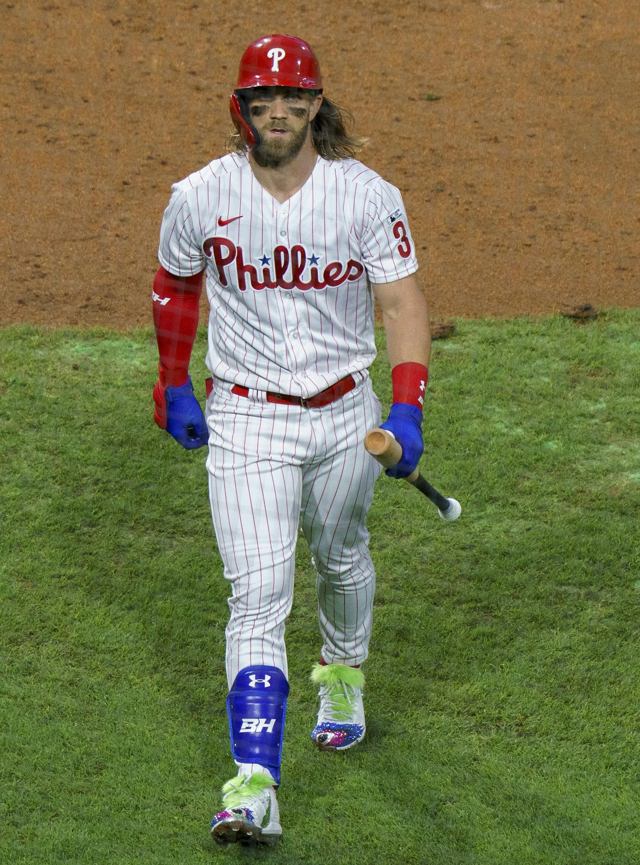 Philadelphia Phillies' Bryce Harper walks back to the dugout after striking out swinging during the third inning of a baseball game against the Miami Marlins, Friday, July 24, 2020, in Philadelphia. (AP Photo/Chris Szagola)