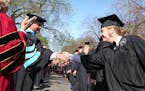English major Connor Doebbert shook hands with Prof. George Dierberger before spring 2017 commencement at Augsburg University in Minneapolis. The numb