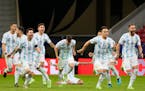 Argentina players celebrate defeating Colombia in a penalty shootout Wednesday during a Copa America semifinal match on July 7 at the National stadium