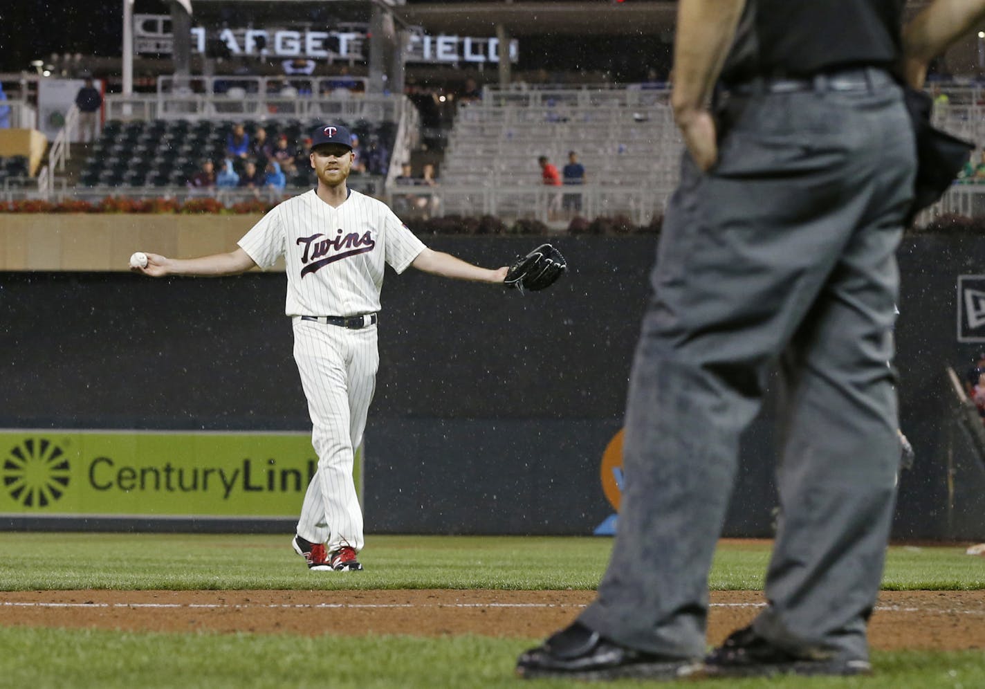 Minnesota Twins pitcher Michael Tonkin throws his arms wide, questioning the decision to halt play for rain in the 11th inning of the Twins' baseball game against the Cleveland Indians on Saturday, July 16, 2016, in Minneapolis. (AP Photo/Jim Mone)