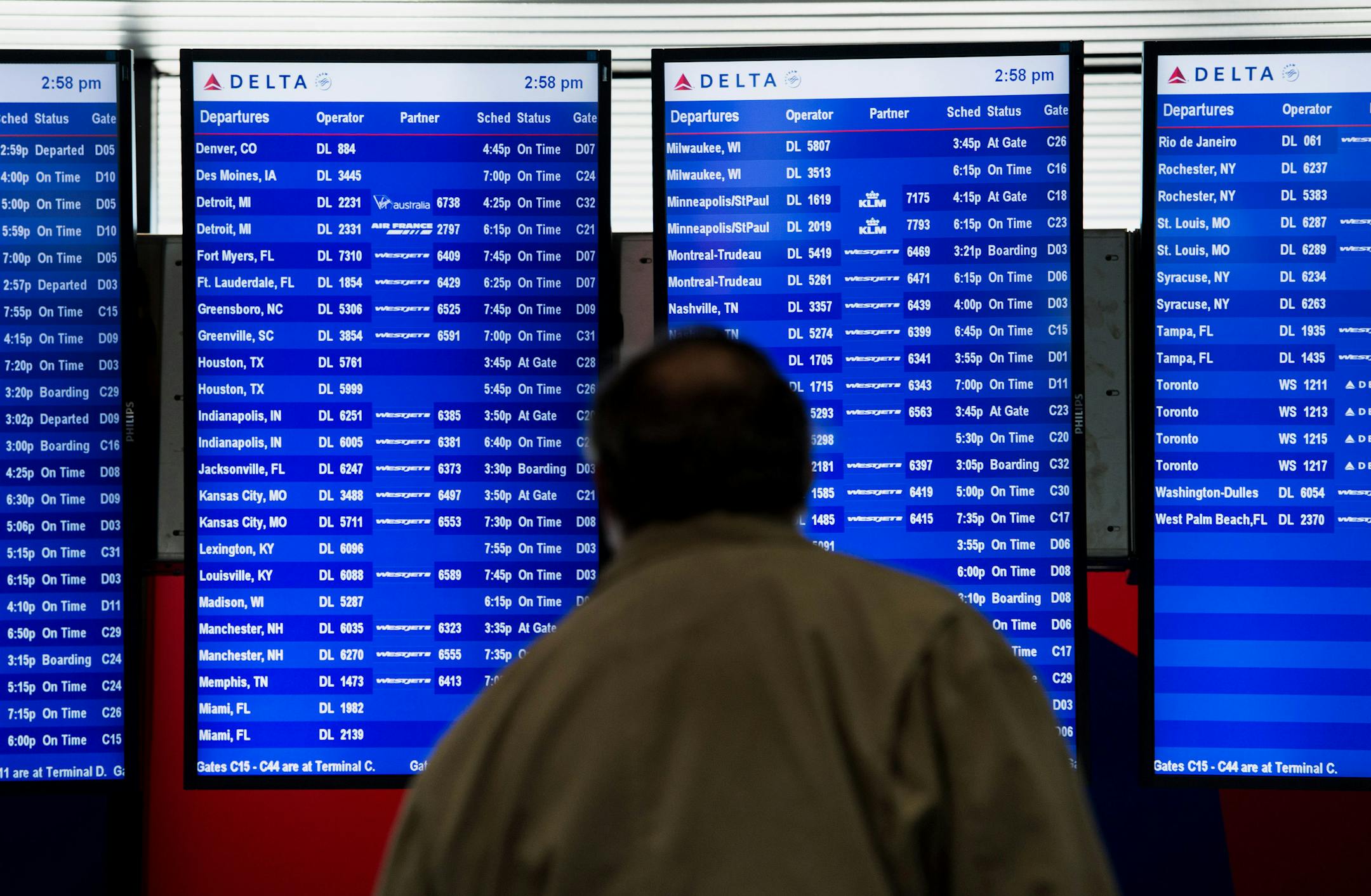 A man views the departure schedule at LaGuardia Airport (LGA) in New York, U.S., on Monday, Oct. 21, 2013. Delta Air Lines Inc. is scheduled to release earnings figures on Oct. 22. Photographer: Ron Antonelli/Bloomberg