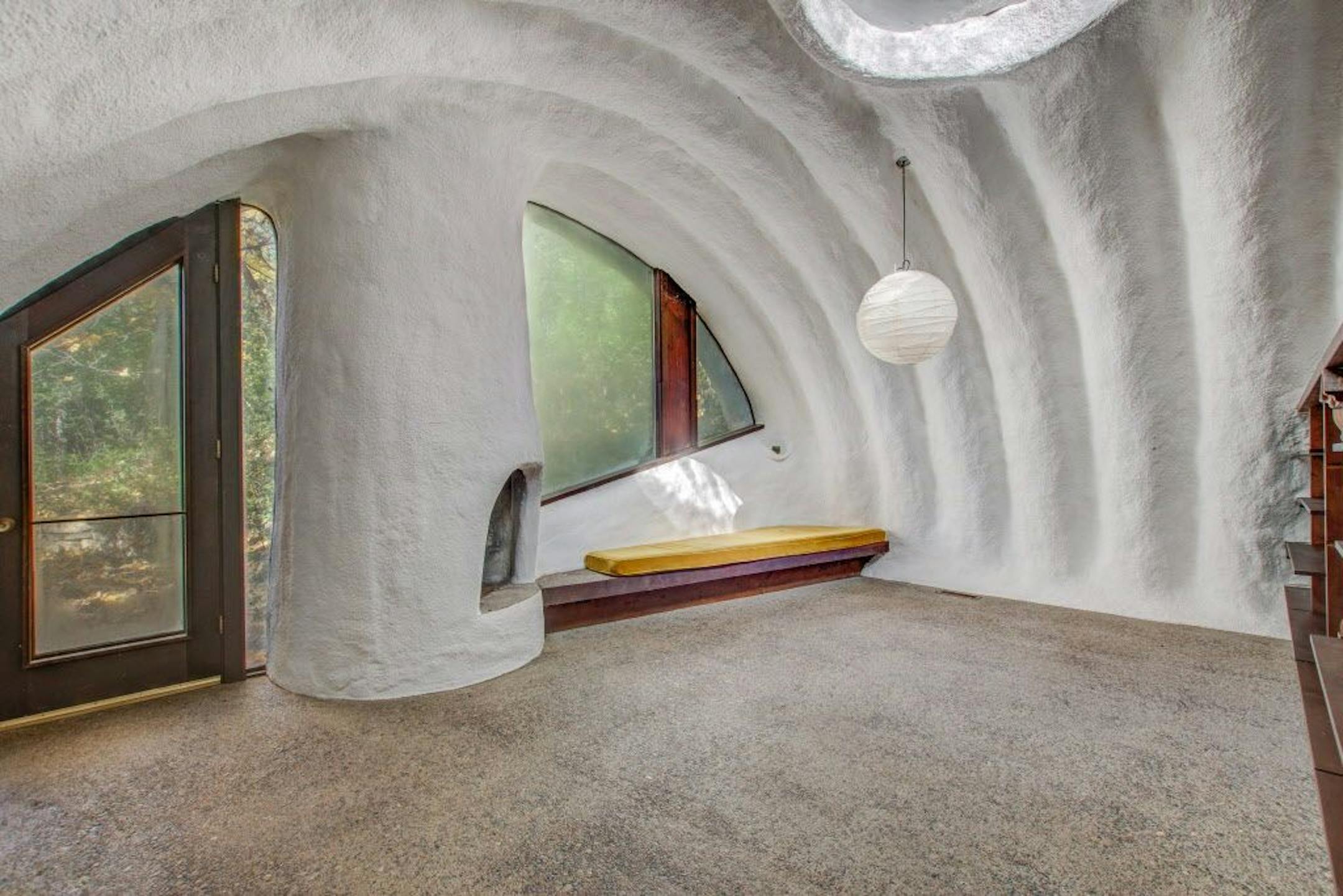 The bedroom's living area steps out to a patio.
